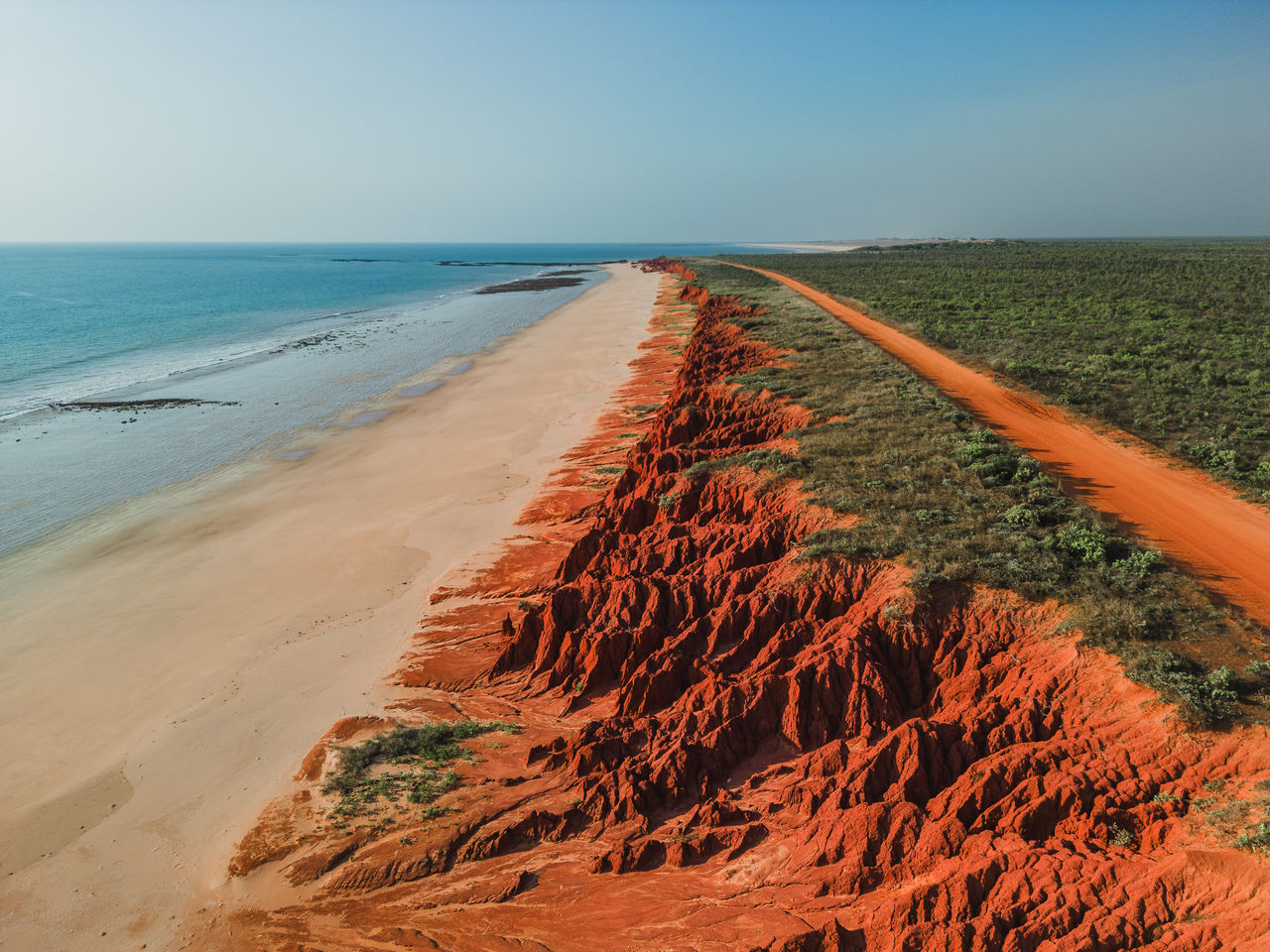 Coastline with red dirt road 