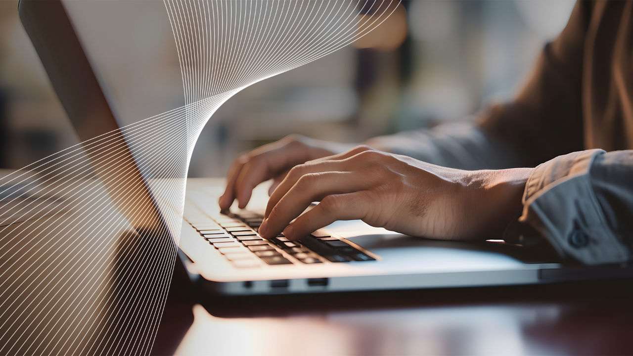 Close up of a business man working on a laptop, typing with his hands for work in office environment home office